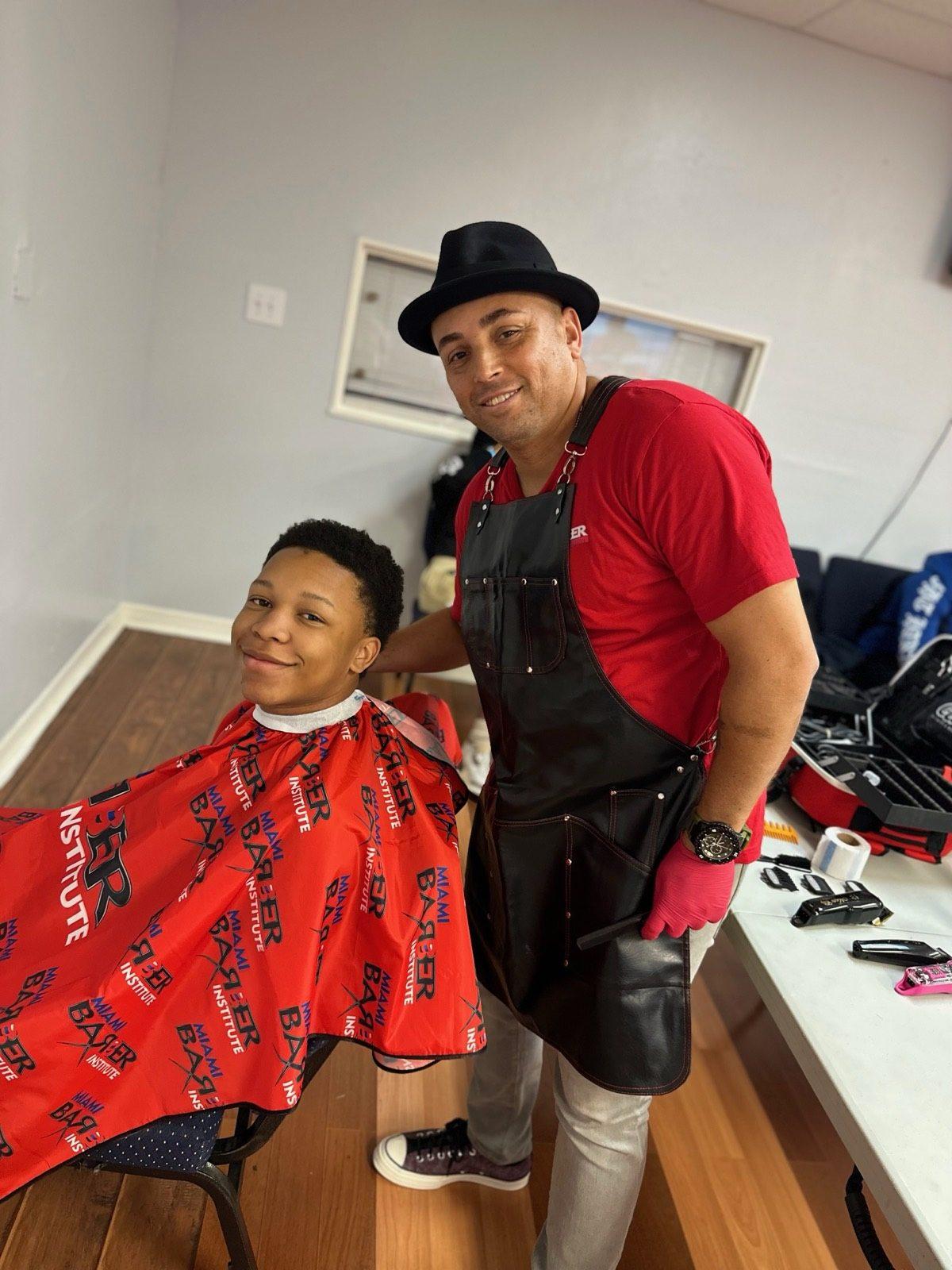 A student learning barbering technique at a demonstration chair