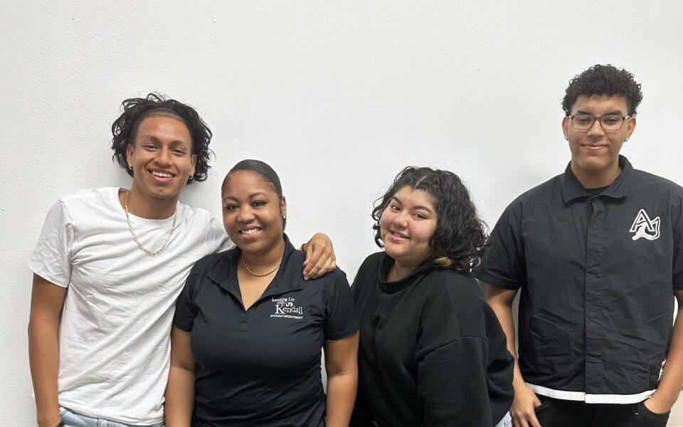 Dade Prep Academy students smiling together in a school hallway