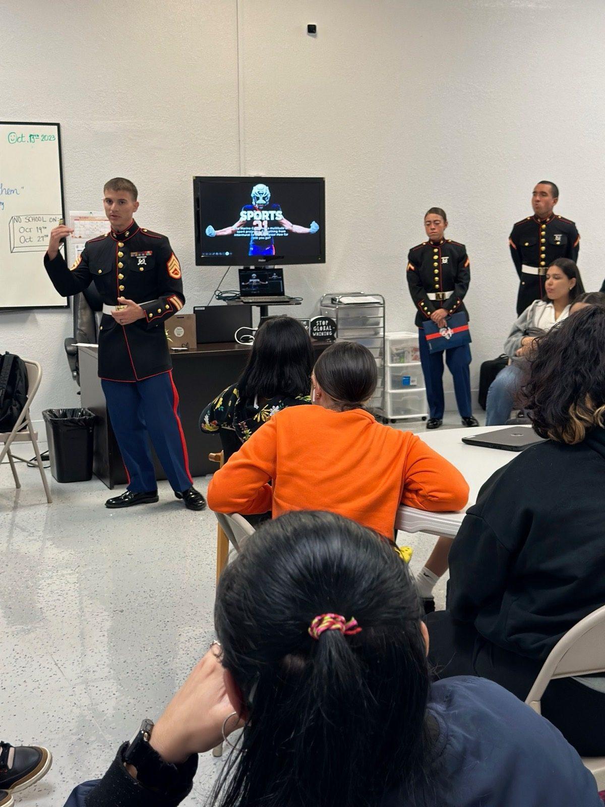 A U.S. Marine Corps representative speaking with students in a classroom